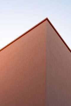 Minimal peach building corner against clear sky