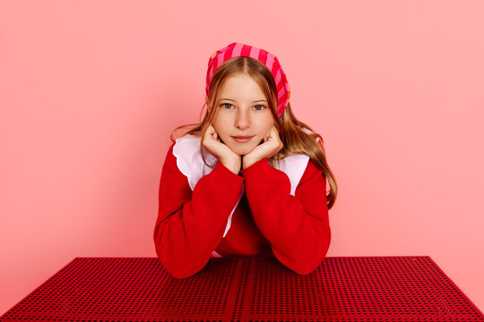 Girl wearing bandana resting chin on hands