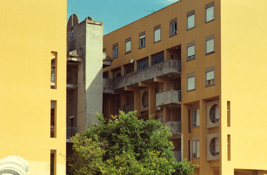 Yellow Social Housing With Concrete Walkways