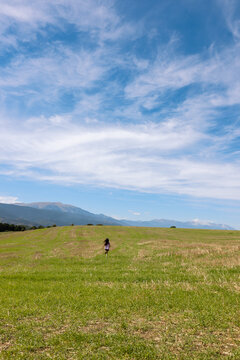Freedom. Child Running on Green Field. France