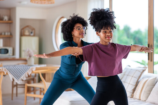 Mom and daughter working out at home