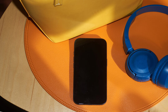 Phone with blank screen placed on a orange placemat