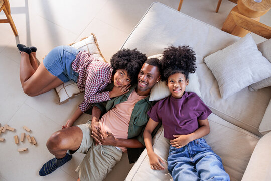 Family of three relaxes together at home
