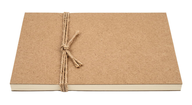 Closed notebook with a rustic brown cardboard cover tied with a simple natural jute twine knot