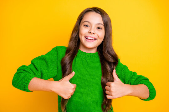 Portrait of positive cheerful kid future promoter have fun show thumb up advis eads choose choice decide decision slect promo wear style stylish clothes isolated over yellow color background