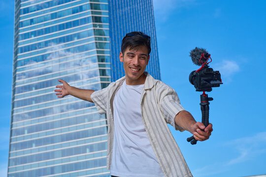 Young male content creator recording city vlog
