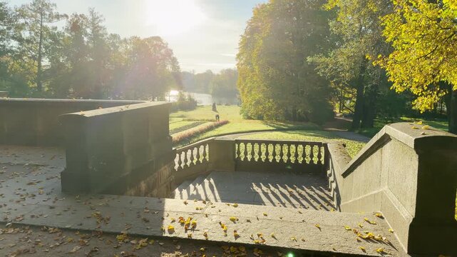 Tracking shot of an empty autumn staircase on gimbal in Catherine Park, Pushkin, Saint Petersburg. Smooth sideways camera movement, no people, evoking peaceful, serene feelings.