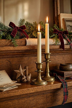 Traditional holiday decor combines patinated brass, natural wood, velvet ribbon and treasured cards for an inviting family interior.