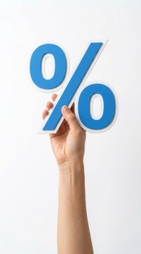 Hand holding a large blue percent sign against a plain white background