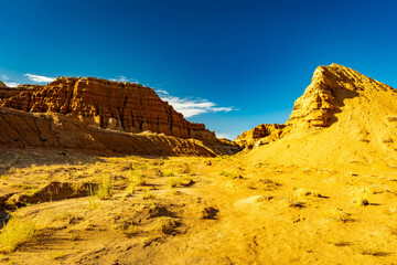 Weathered sandstone hoodoo pillars stand against clear desert sky © PhotoSpirit