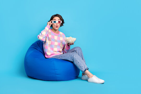 Full size profile side photo of young girl wear glasses impressed horror cinema  isolated over blue color background