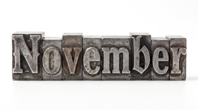 November word spelled out with vintage metal letterpress type blocks isolated on white background