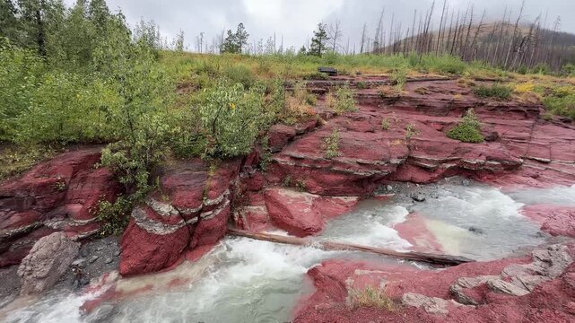 Red rock layers and rushing creek Waterton Lakes Canada