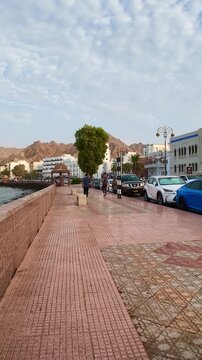 Muttrah Corniche in Muscat, Oman, featuring waterfront views, traditional architecture, harbor scenery, and coastal mountains. Muscat, Oman - August 03, 2026