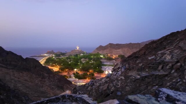 Scenic views of Muttrah in Muscat, Oman, featuring rocky mountains, green parks, traditional buildings, and coastal harbor views. Muscat, Oman - October &lrm;21, &lrm;2026.