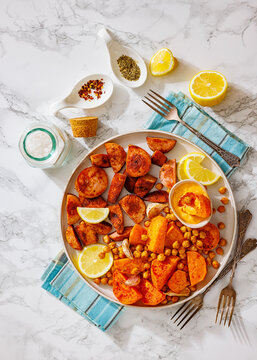 roasted sliced sausage with sweet potato on plate