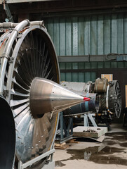 Aircraft jet engines stand in a repair workshop, showcasing advanced turbine technology, complex mechanical components and professional aviation maintenance equipment © Harmony Video Pro