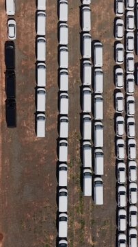 Aerial view of rows of parked cars in a large parking lot