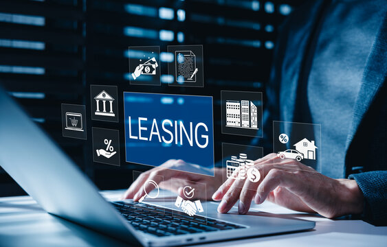 Leasing and Financial Service Concept. Businessman using laptop with icons related to leasing, finance, housing, automotive, interest rates, and monthly payments. lease agreement, leasing car,