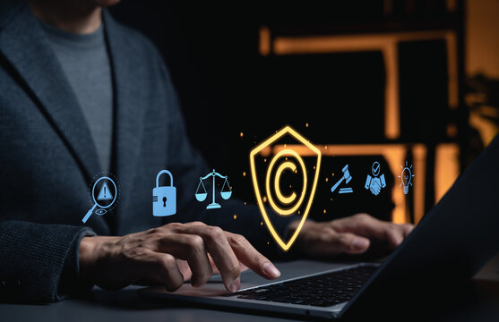 Copyright protection concept. Lawyer using laptop with copyright shield, intellectual property, legal security, ownership rights, patent licensing, compliance, creative asset protection, business law