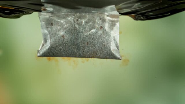 Super Slow Motion of Falling and Extracting Tea Bag in Hot Water at 1000fps.