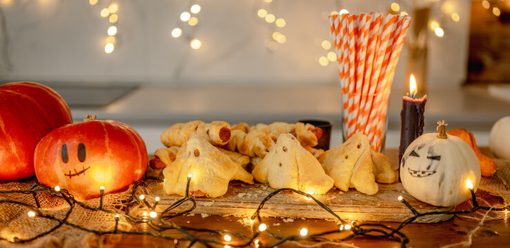 Spooky halloween food table decoration with pumpkins
