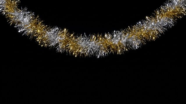 Silver and gold tinsel garland on black background, Christmas decoration border overlay