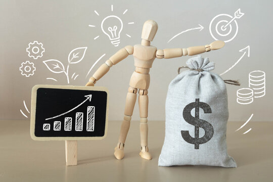 Financial Growth and Wealth Building Concept with Wooden Mannequin Money Bag and Rising Business Chart.