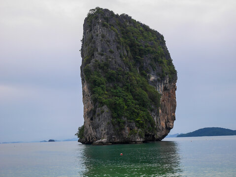 Majestic limestone cliff island with lush tropical forest in Thailand