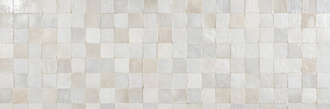 Panoramic handcrafted off white zellige ceramic tile wall surface with subtle glossy glaze