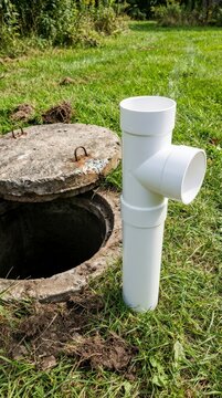 Septic baffle tee beside an open tank access