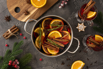 Mulled wine in a pot with orange, cinnamon, and star anise for a cozy Christmas celebration
