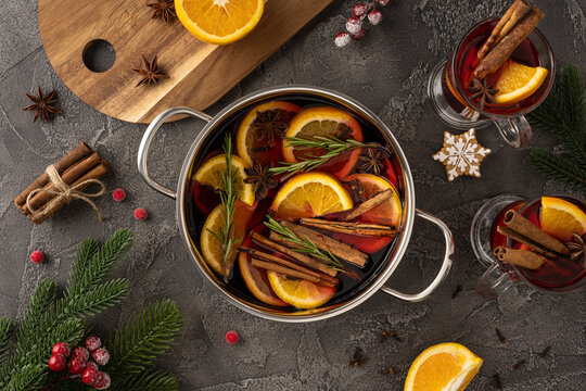 Mulled wine in a pot with orange, cinnamon, and star anise for a cozy Christmas celebration