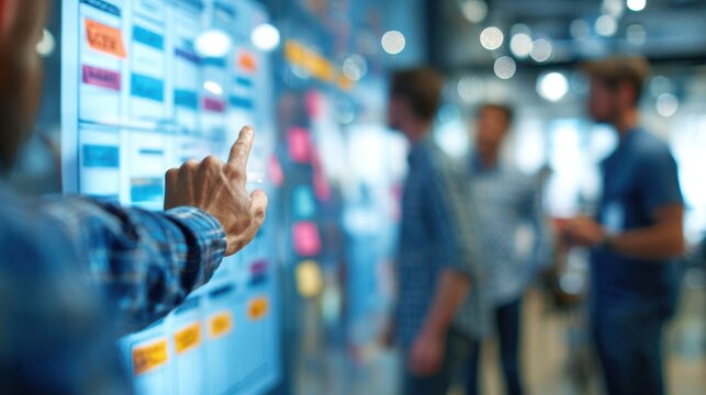 Medium shot of a team lead reviewing model approval workflows on a touchscreen foreground in sharp focus with softly blurred team members symbolizing collaborative MLOps.