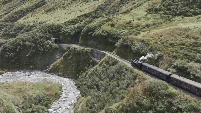 Steam railway, train with steam locomotive approaching tunnel, Furka steam railway near Tiefenbach station, Furka Pass, Uri, Switzerland
