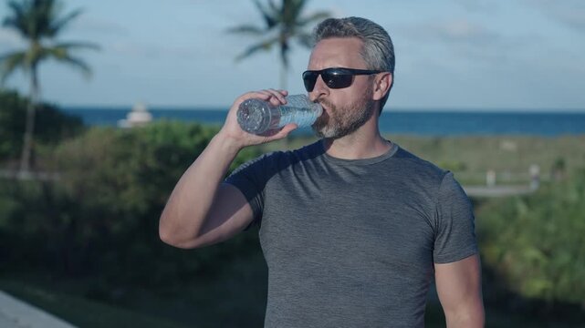 Thirsty man drink water. Sport runner man has thirst. Healthy lifestyle. Water balance in body. Sport man feel thirst drinking water. Hydration vitality. Be hydrated. Thirsty runner after workout