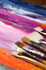 Various Old Artists Painter Brushes on Colorful Background © rstpierr