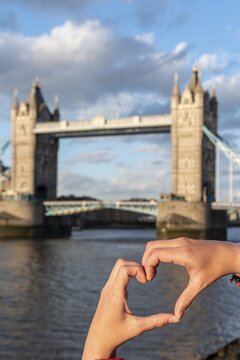 Hands form a heart, behind Tower Bridge over the Thames, London, England, Great Britain