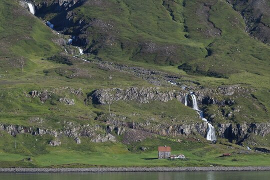 Remote farm in front of a waterfall, Sey&eth;isfj&ouml;r&eth;ur, Austurland, East Iceland, Iceland