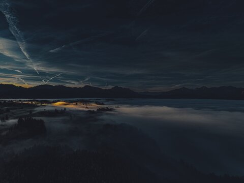 Autumn sunrise in the foothills of the Alps with fog at Illasbergsee and Forggensee near Halblech in Allg&auml;u, Bavaria, Germany