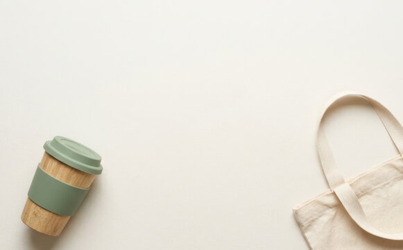 Eco friendly reusable bamboo coffee cup and cotton tote bag flat lay concept with copy space