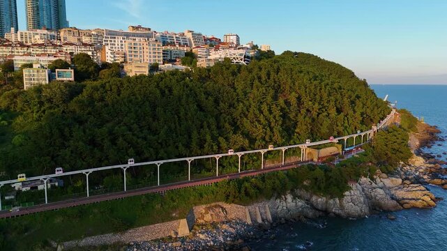 Haeundae blueline park sky capsule monorail moving along busan coastal cliff