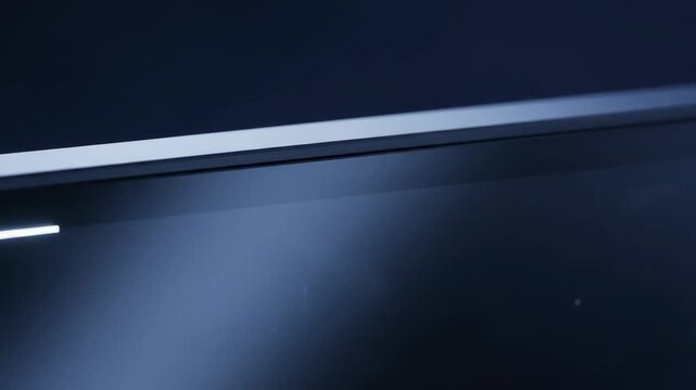 Corner of computer monitor displaying glowing white framing guide angle bracket on screen