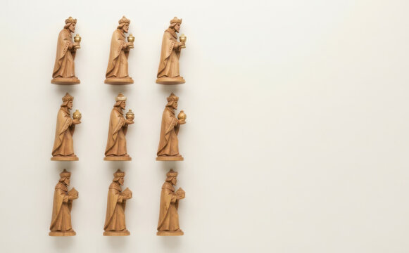 Wooden nativity figures arranged in grid on white background for Christmas design