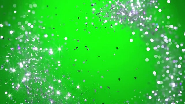 Gentle silver glitter rain swirling in a slow circular motion over a green screen surface for artistic compositing