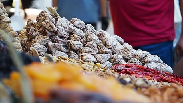 Vendors display dried fruits and nuts at a market stall