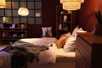 Cozy bedroom interior, home comfort and relaxation with warm ambient lighting, modern furniture and soft bedding in a stylish apartment © Pixel-Shot