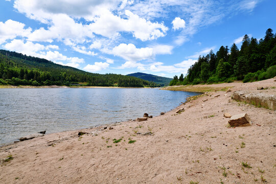 Beautiful mountain lake in the Black Forest in Forbach in Germany called Schwarzenbach Reservoir surrounded by forested hills under a clear sky