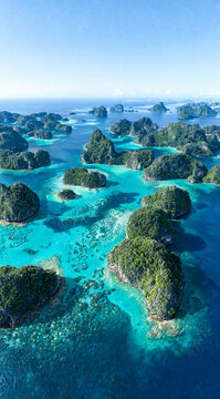 Aerial View of Limestone Islands and Turquoise Lagoons in Raja Ampat Indonesia Portrait Ratio