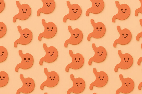 Cute cartoon stomach pattern on soft peach background, digestive health icons with happy faces, flat paper cutout style texture